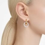 Dextera hoop earrings, Asymmetrical design, Interlocking loop, White, 18K gold finish - Image 2